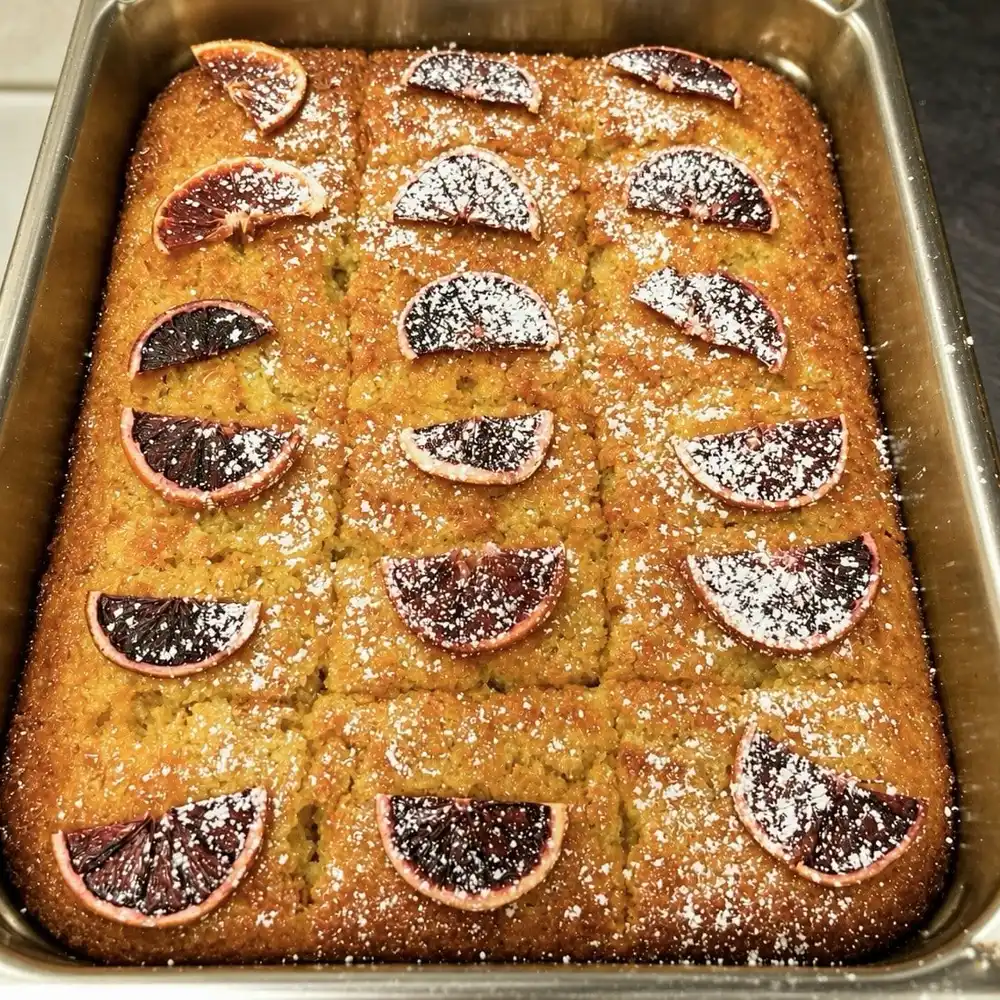A tray of portokalopita, Greek orange cake, topped with orange slices